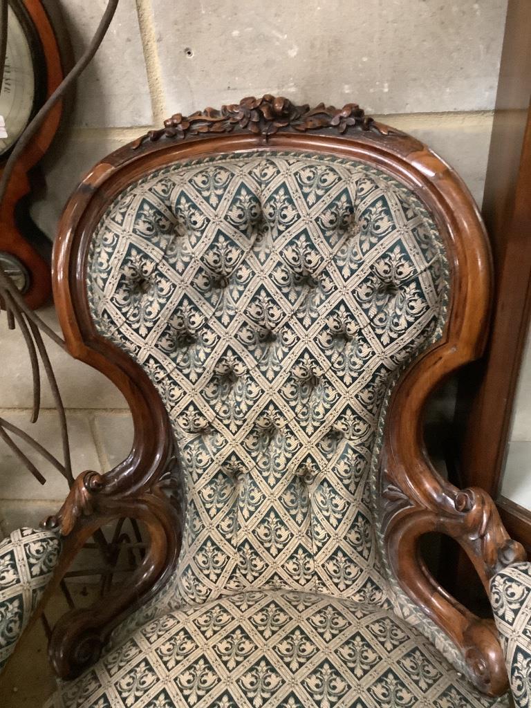 A Victorian carved walnut open armchair, width 66cm depth 75cm height 96cm